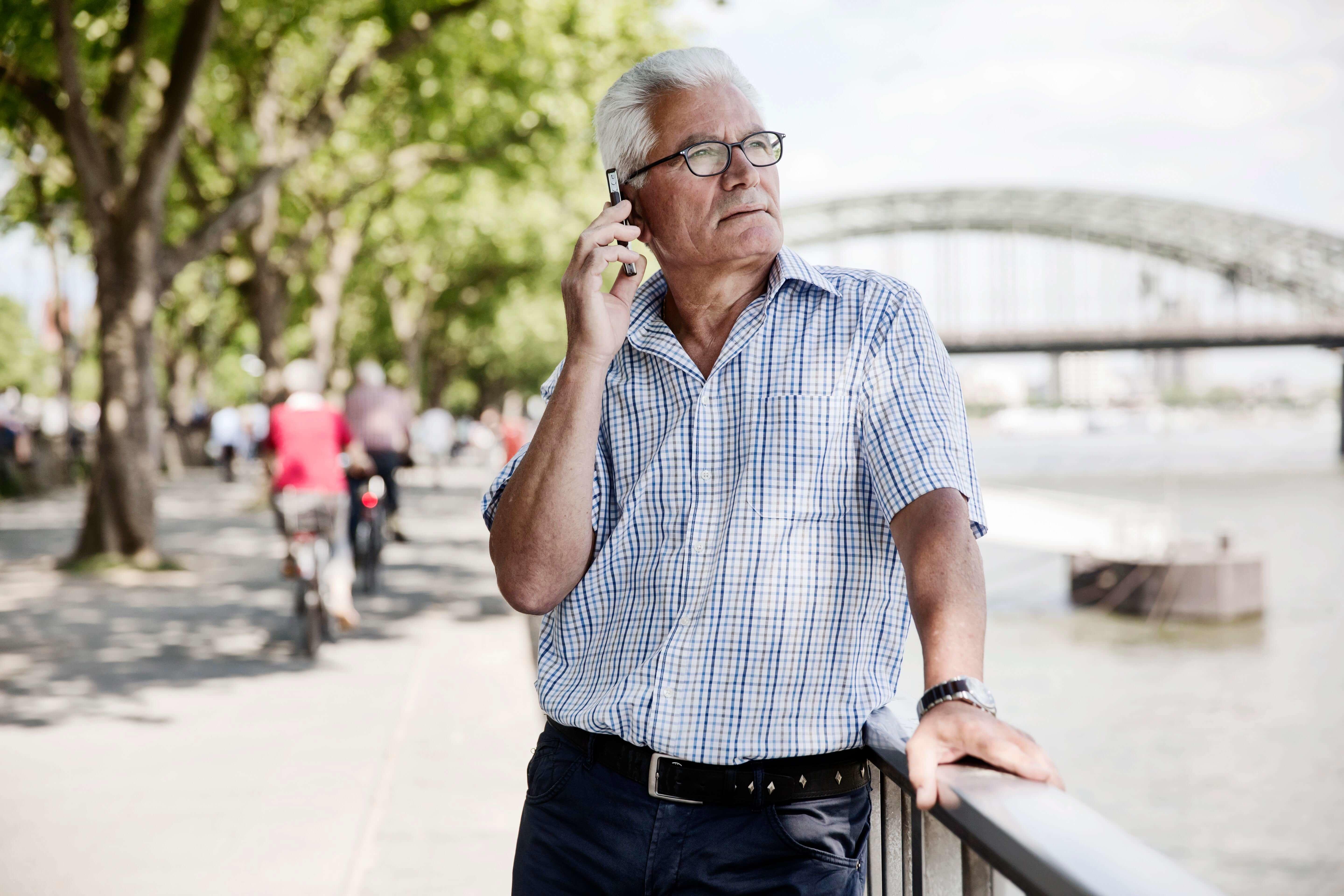 Man speaking on cell phone beside a waterfront